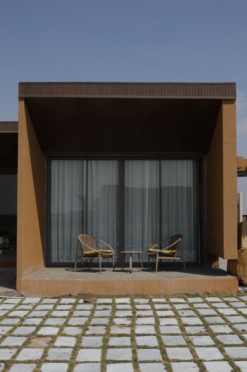 Earth-toned cabin with timber soffit and sliding glass front