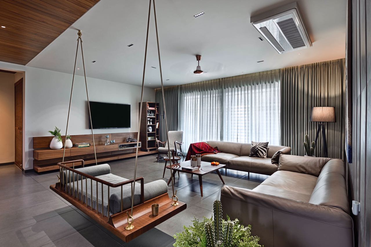 MA HOME living room with wall-mounted TV, timber console and hanging swing