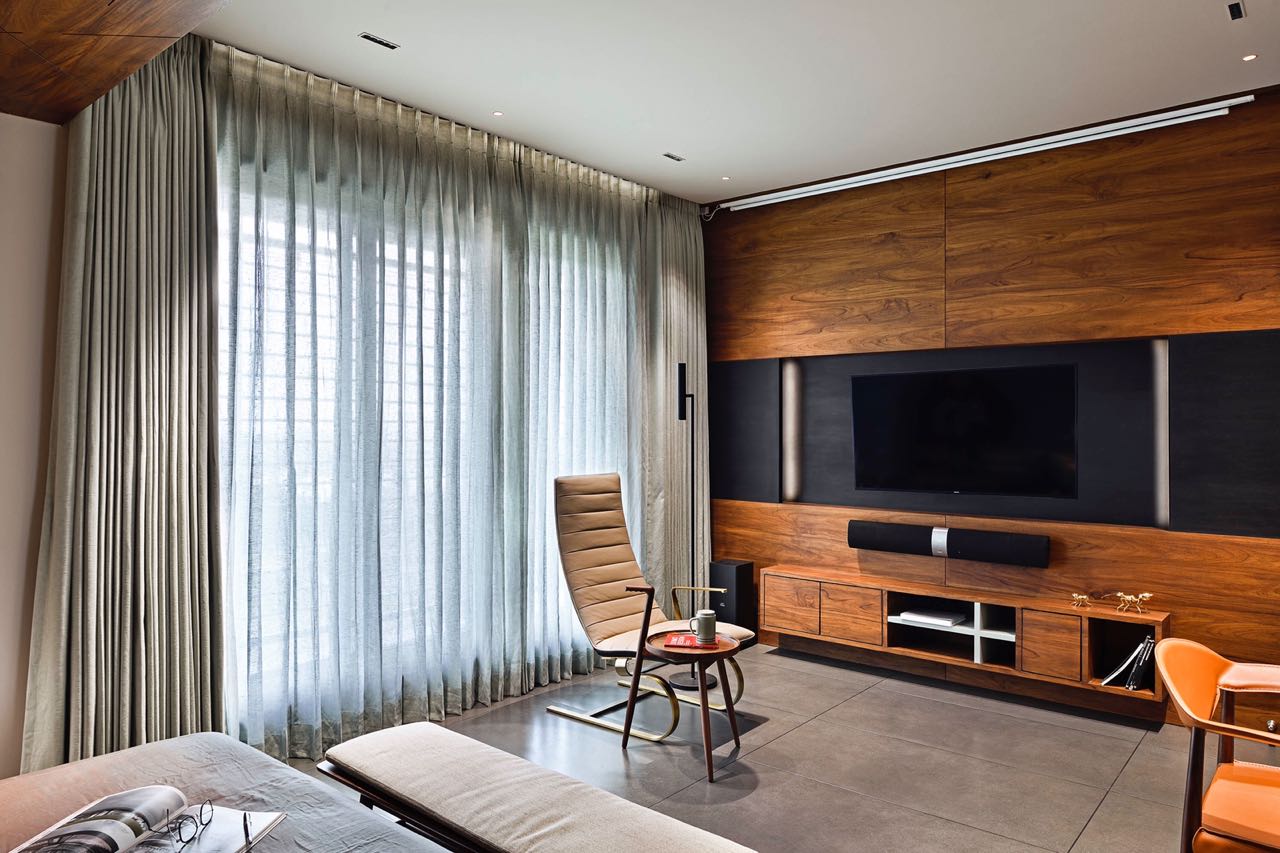 MA HOME family lounge with sheer curtains, leather recliner and teak media wall