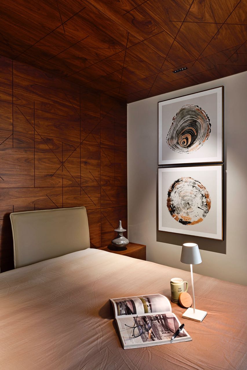 MA HOME bedside with paired tree-ring prints below an inlaid geometric teak ceiling