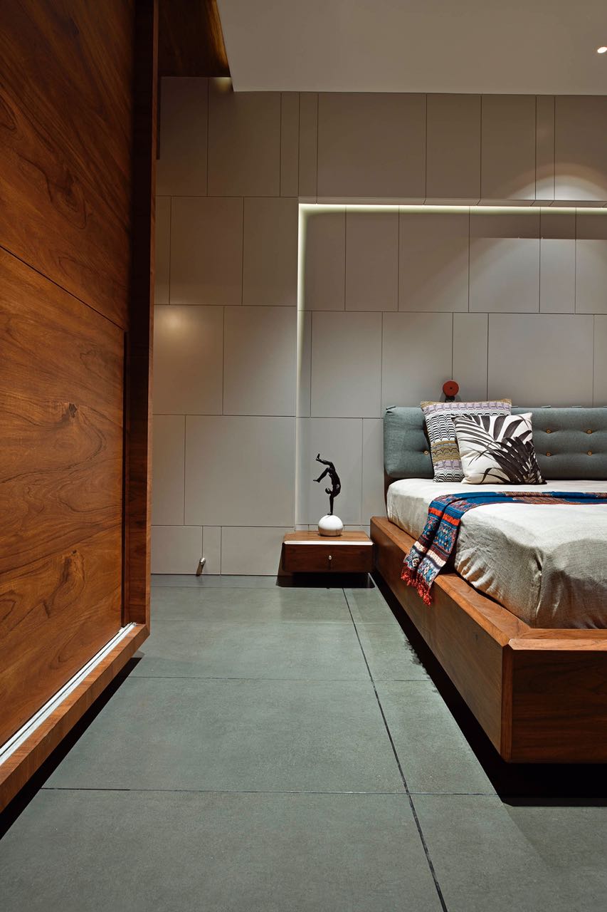 MA HOME guest bedroom with timber bed, plaster-panelled wall and teak partition