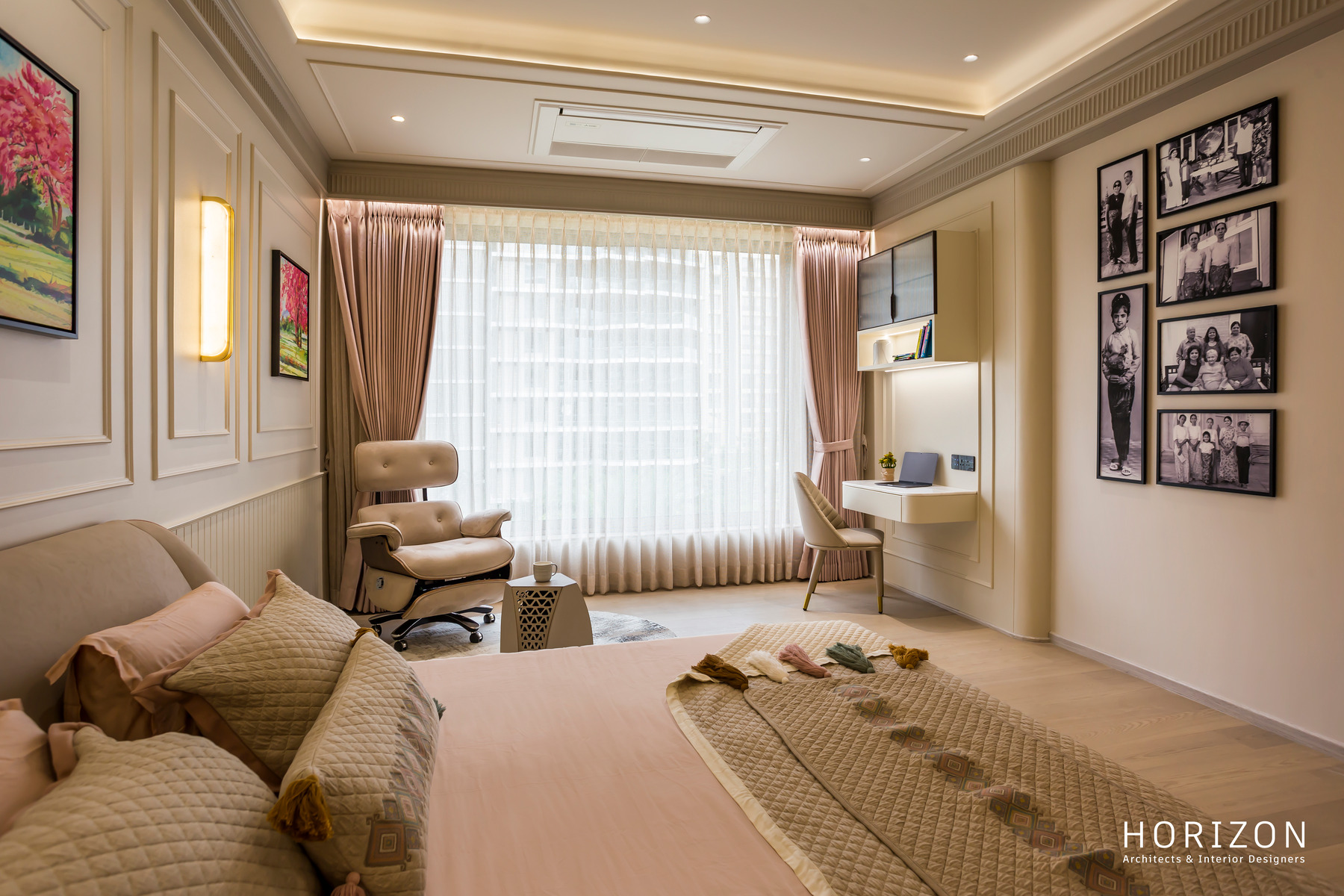 RAHUL BHAI HOME bedroom with a family photo wall, recliner and bed with quilted throw