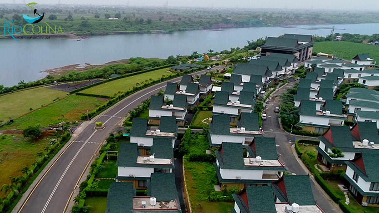 Aerial view of Rio Colina riverside villas along a curving road