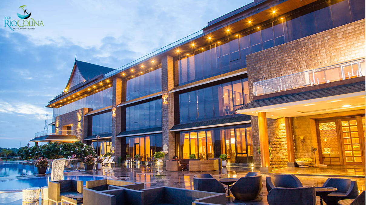 Rio Colina clubhouse and pool lit at dusk