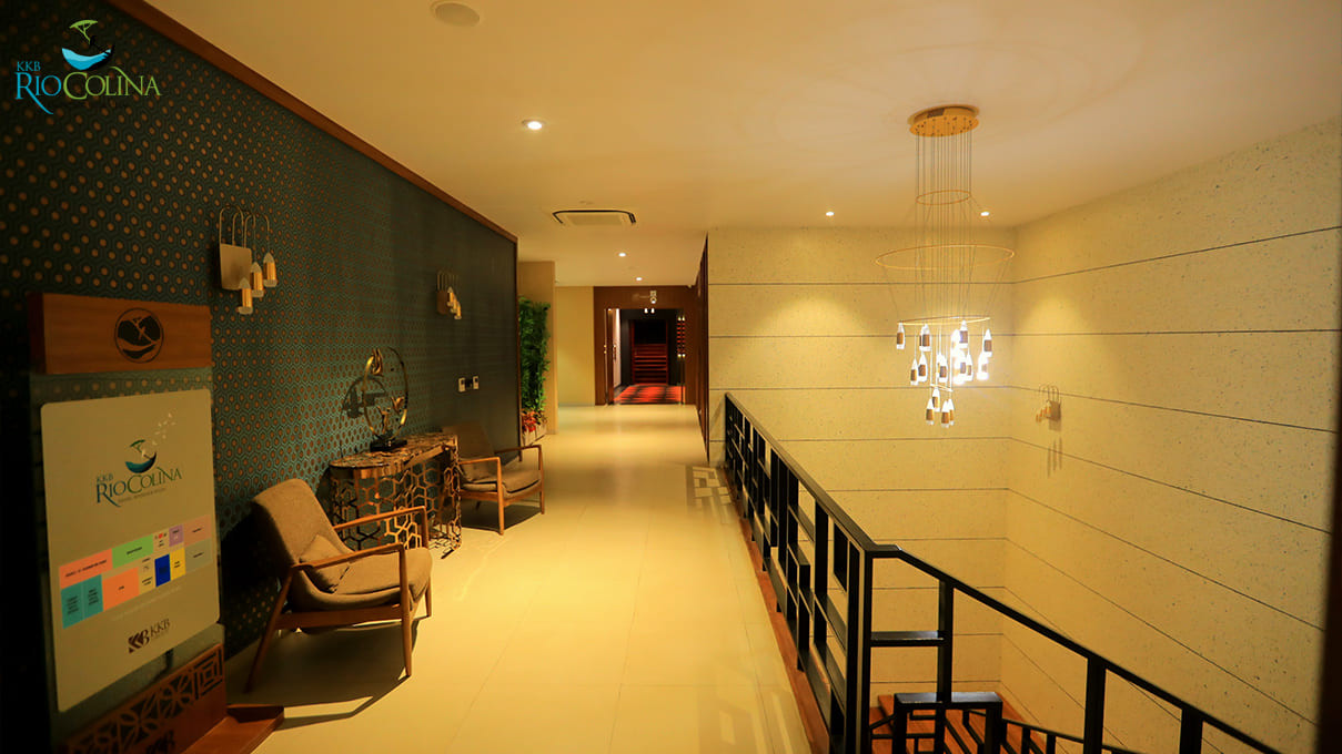 Clubhouse corridor with lounge chairs and cascading chandelier