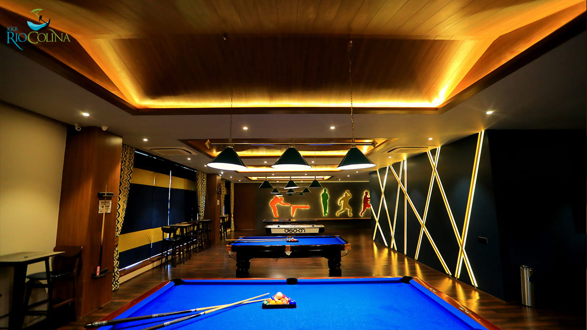 Games room with pool tables and neon sports figures
