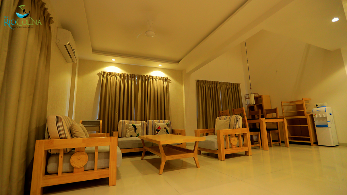 Villa living room with light timber sofas and coffee table