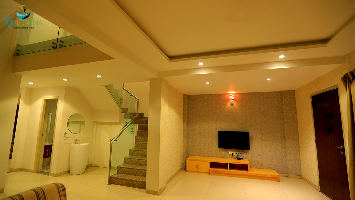 Villa living room with TV wall, glass stair and mezzanine