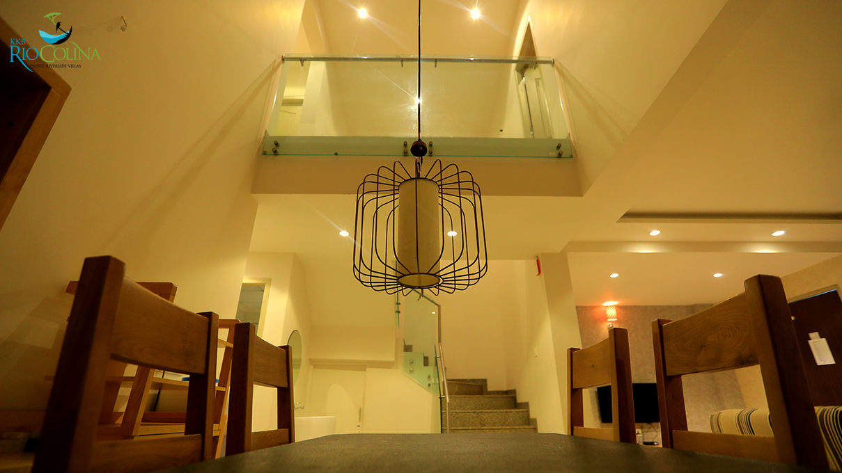 Villa dining space under the mezzanine with caged pendant