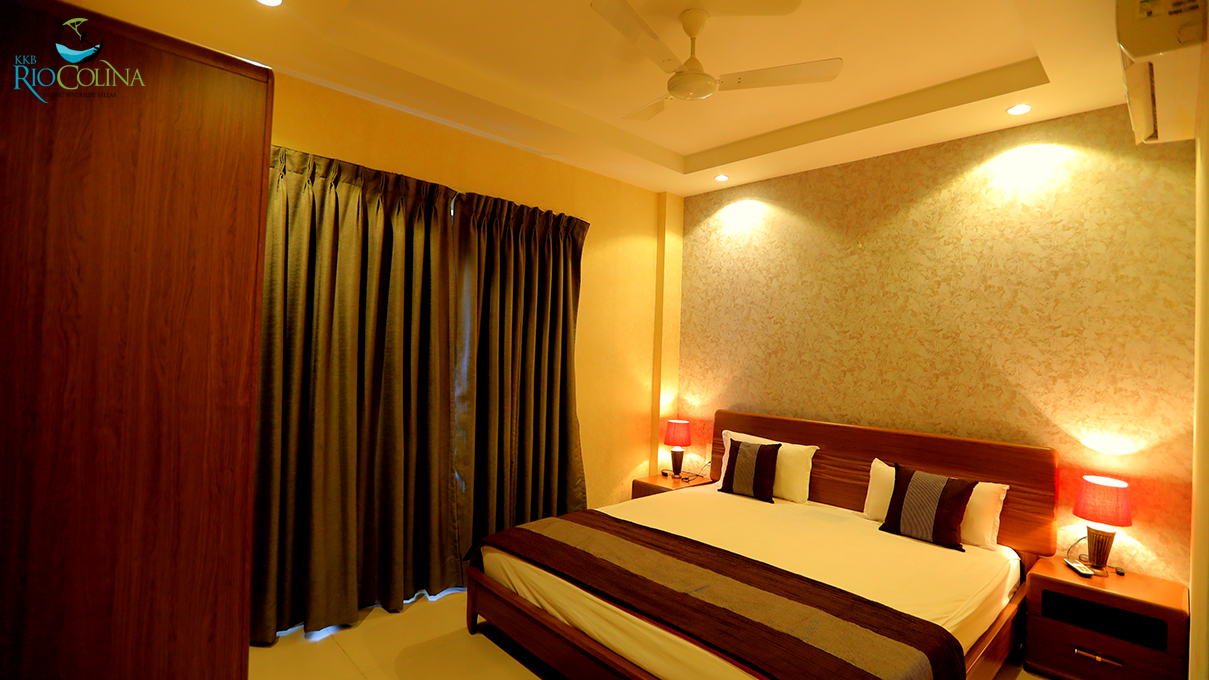 Villa bedroom with red table lamps and textured wall