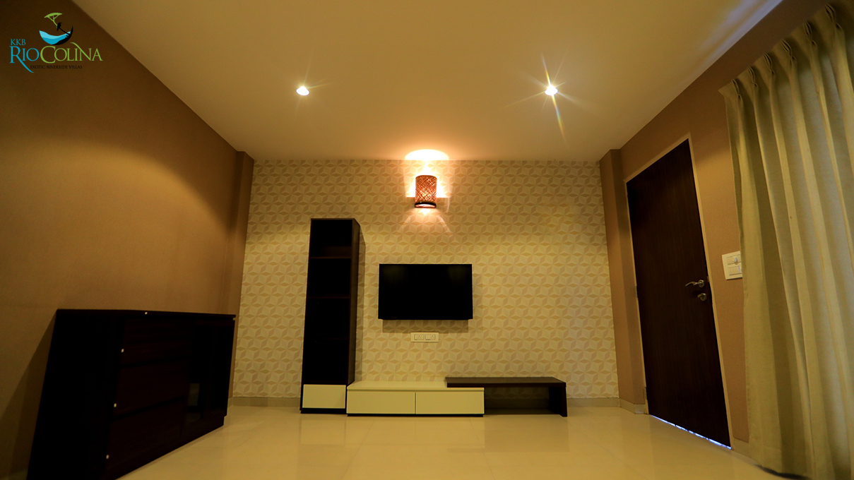 Villa living room with patterned wallpaper and TV unit