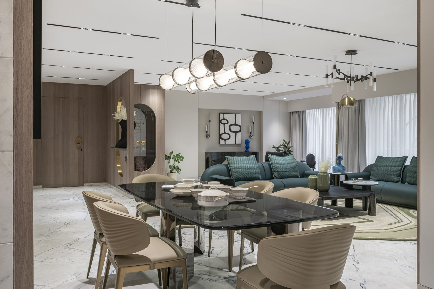 SACHIN BHAI HOME dining table with tubular pendant and living room beyond