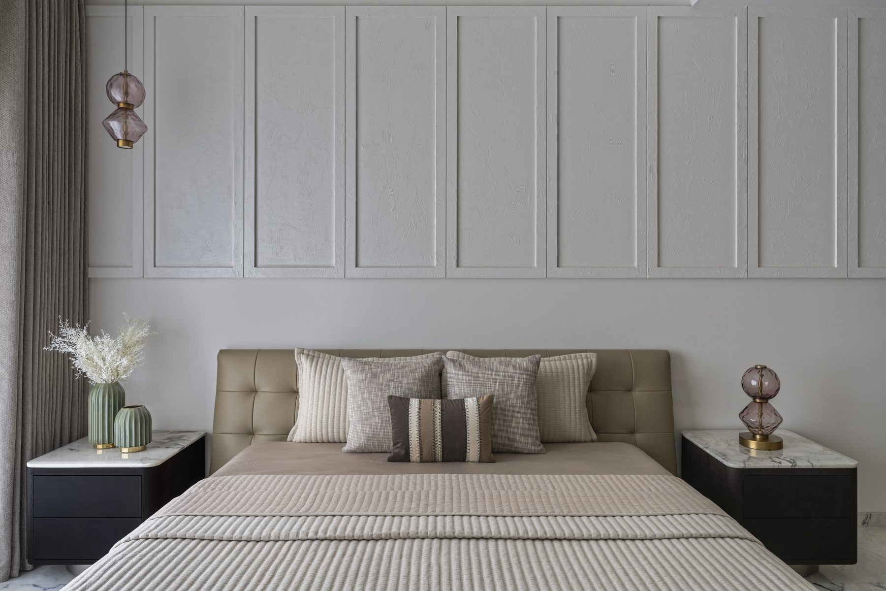 SACHIN BHAI HOME guest bedroom with plaster panelling, tufted leather headboard and pink glass lamps