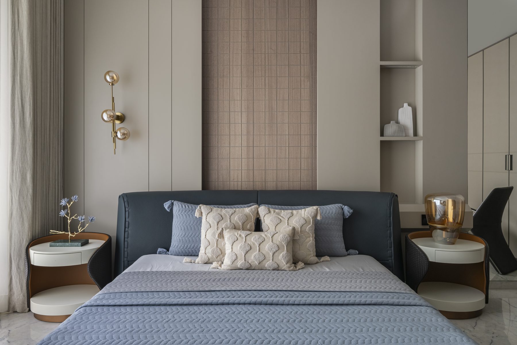 SACHIN BHAI HOME blue bedroom with leather bed, brass sconce and wood mosaic panel