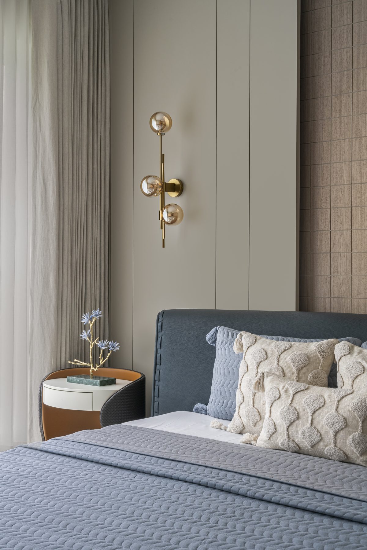 SACHIN BHAI HOME brass three-globe sconce and orange leather nightstand