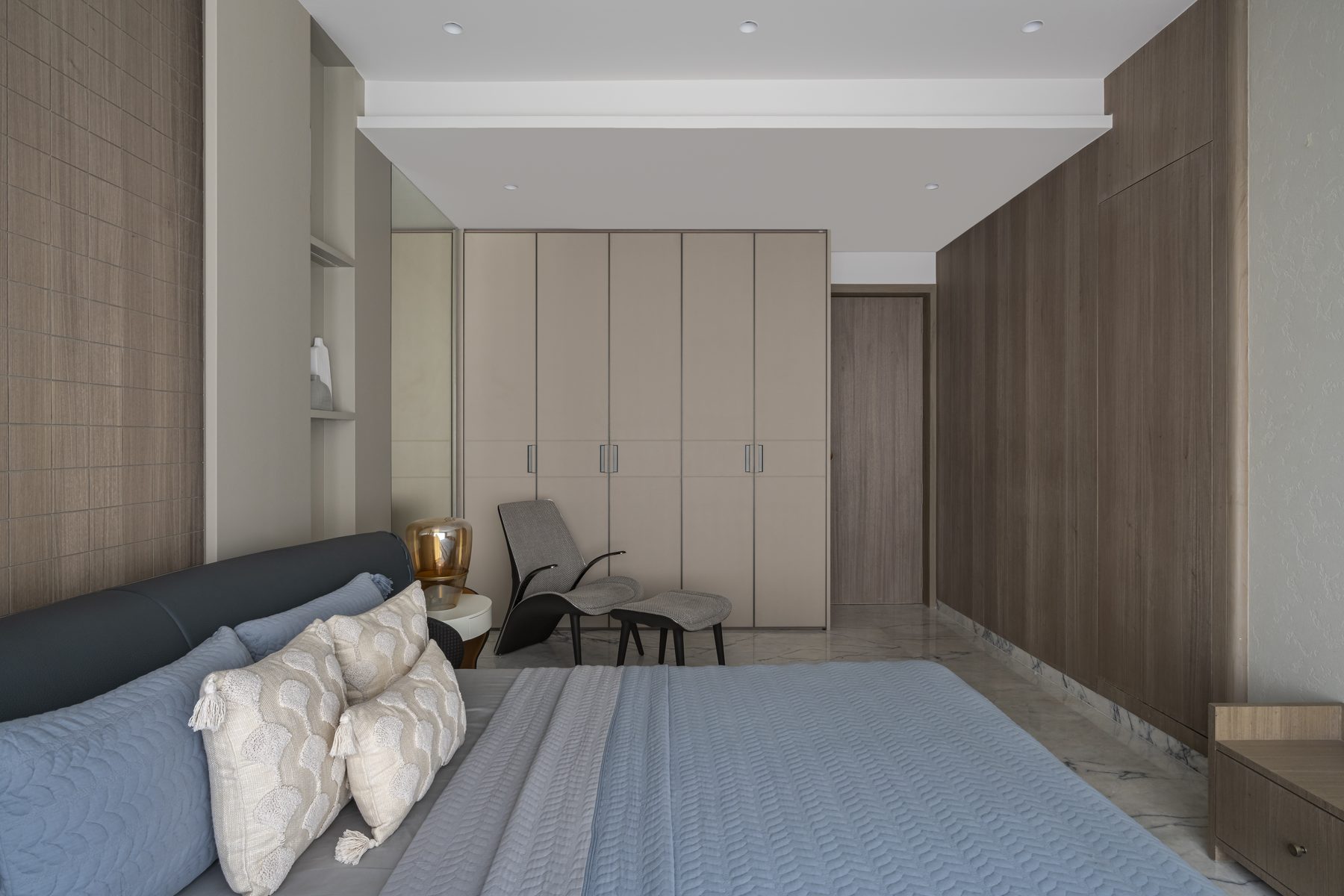 SACHIN BHAI HOME blue suite with wardrobes, lounge chair and amber glass lamp