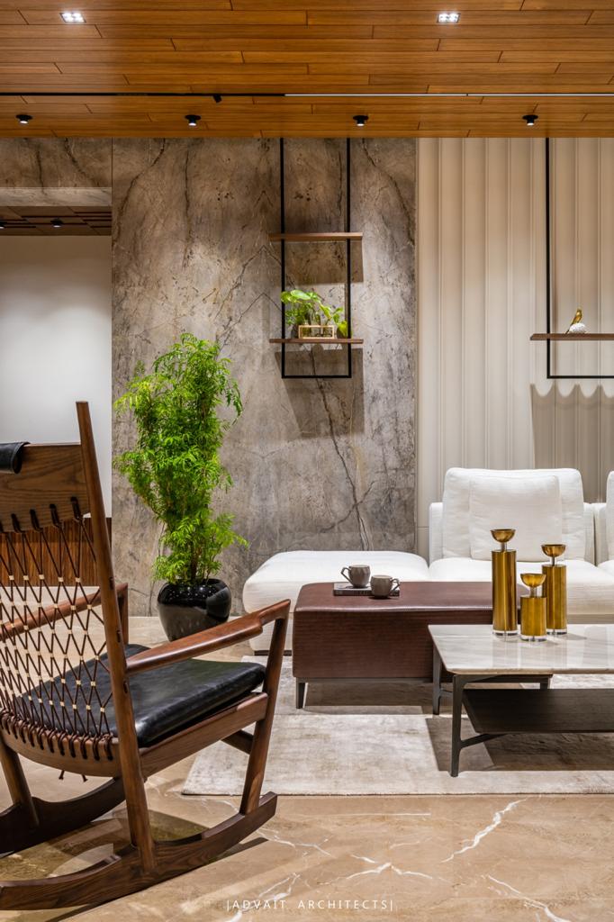 VILLASHBHAI HOME lounge corner with rocking chair, marble panelling and planting