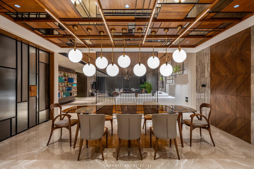 VILLASHBHAI HOME dining room under a timber and brass grid ceiling with globe lights
