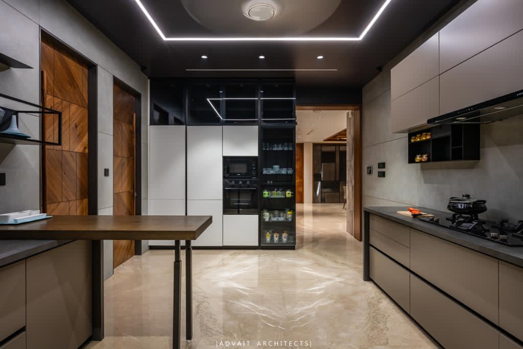 VILLASHBHAI HOME kitchen with tall units, integrated appliances and a breakfast table
