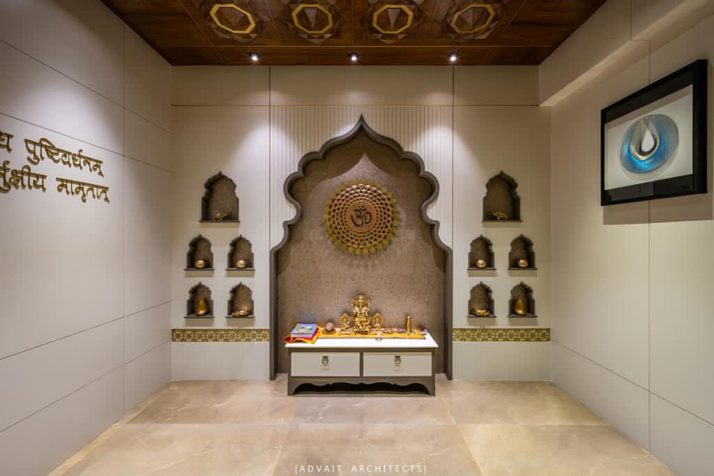 VILLASHBHAI HOME pooja room with brass idols in the arch niche and a decorative ceiling