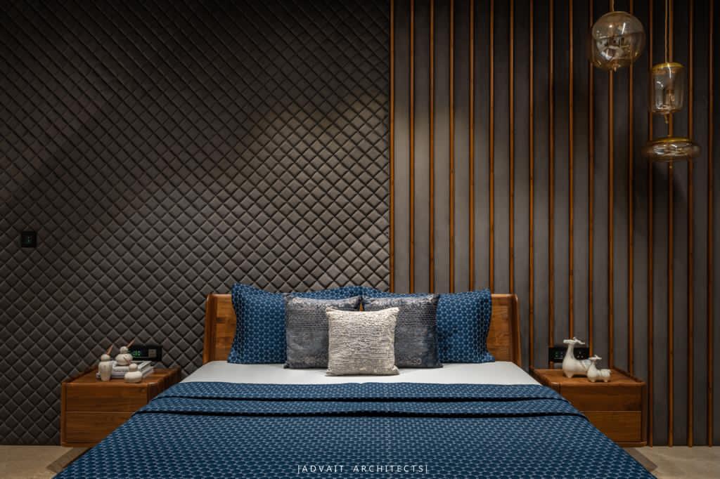 VILLASHBHAI HOME bedroom with a slatted timber headboard wall and quilted blue bedding