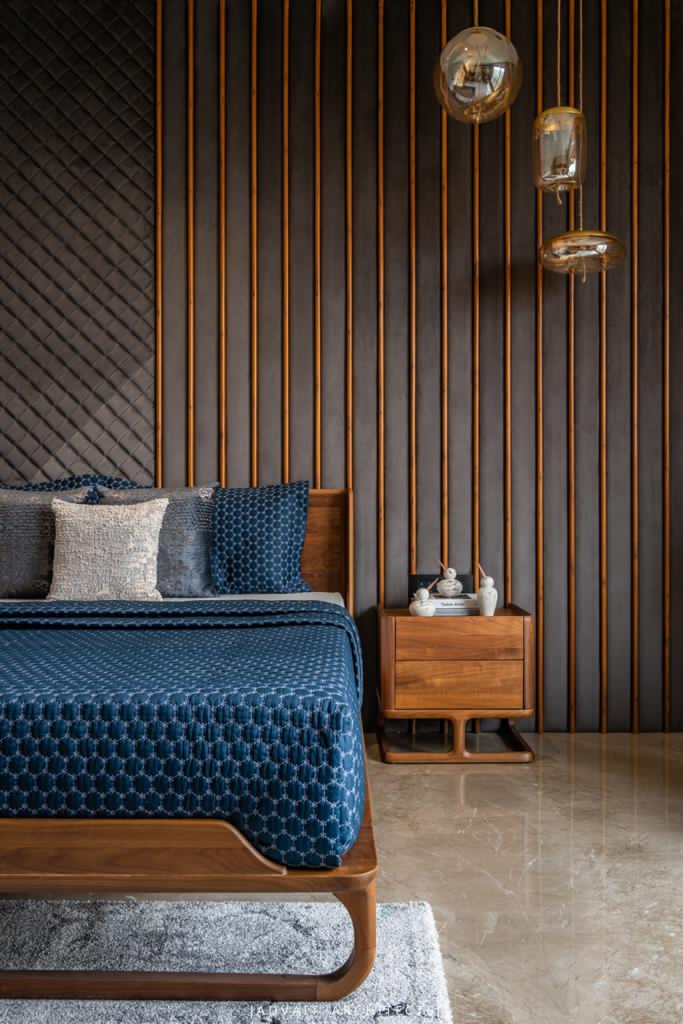 VILLASHBHAI HOME bedside with slatted timber panelling, pendant light and timber nightstand