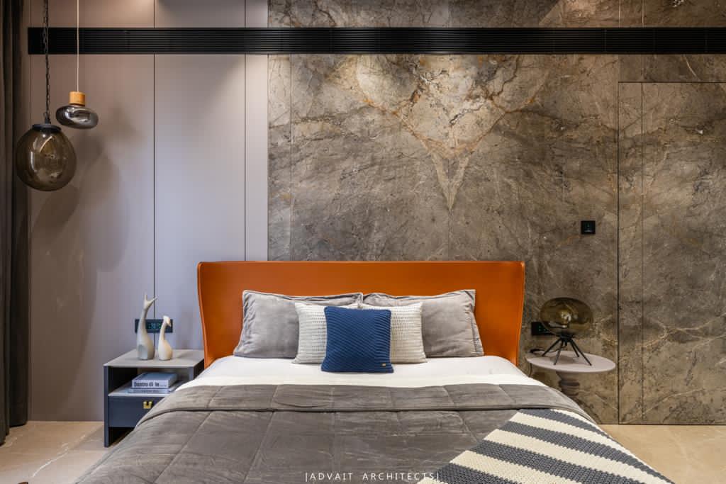 VILLASHBHAI HOME tan leather headboard with marble panelling and a pendant light