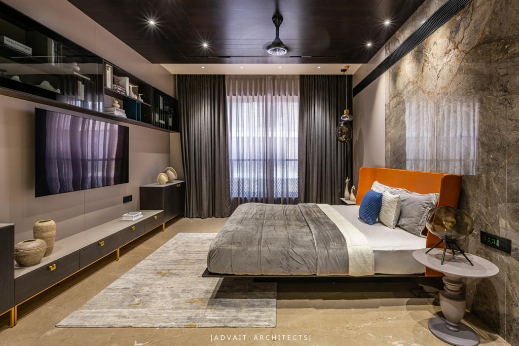 VILLASHBHAI HOME bedroom with tan headboard, marble wall and a long timber media console