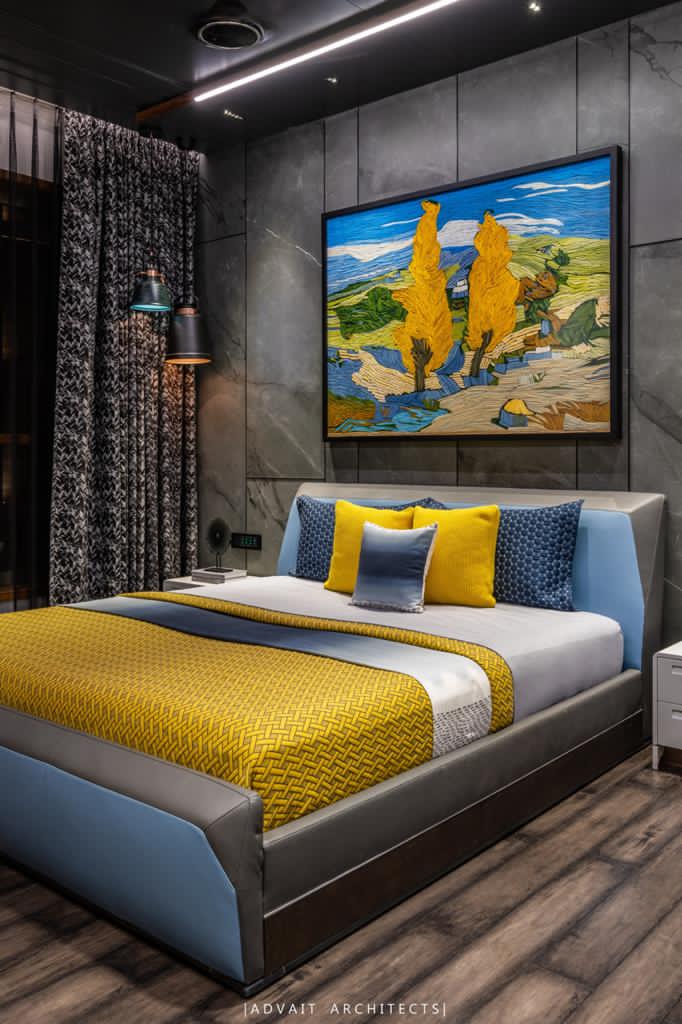 VILLASHBHAI HOME bedroom with yellow and grey bedding against a stone feature wall