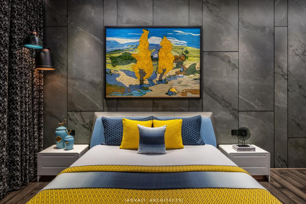 VILLASHBHAI HOME bedroom with a landscape painting above yellow and blue bedding
