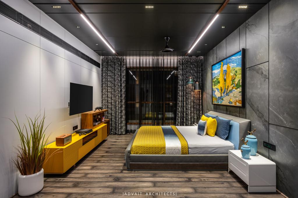 VILLASHBHAI HOME bedroom with yellow bedding, media console and a tall planter
