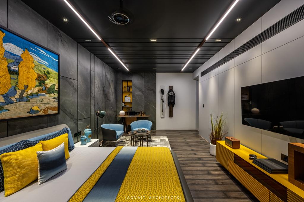 VILLASHBHAI HOME bedroom seen wide, with yellow bedding, artwork and a media wall