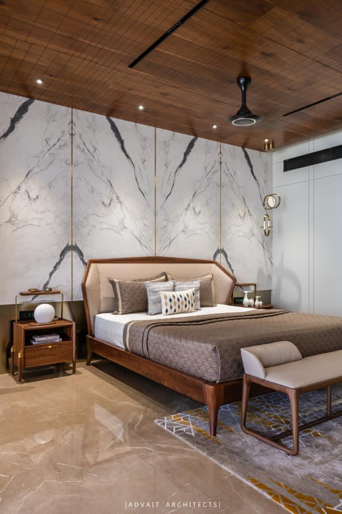 VILLASHBHAI HOME bedroom with a timber bed, bench and veined marble headboard wall