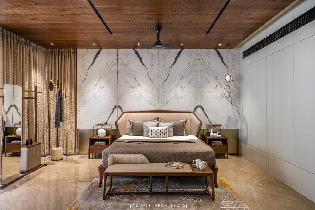VILLASHBHAI HOME bedroom with upholstered headboard, marble panelling and a foot bench