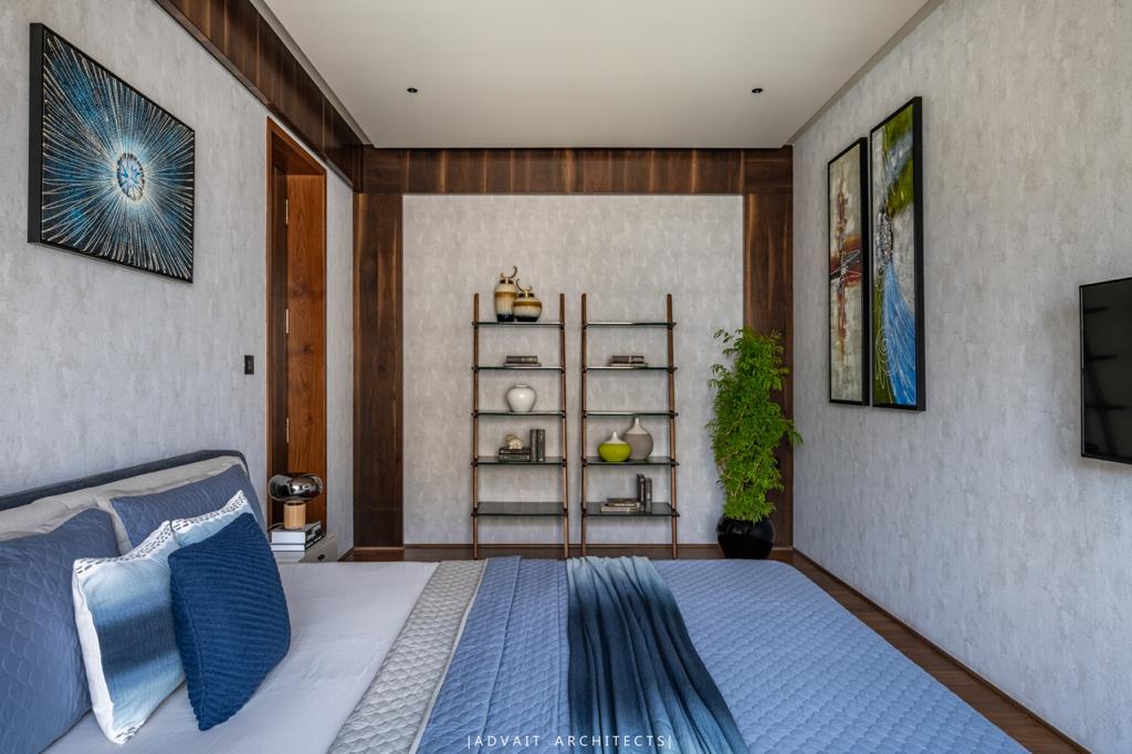 VILLASHBHAI HOME bedroom with blue and white bedding, open shelving and framed artwork