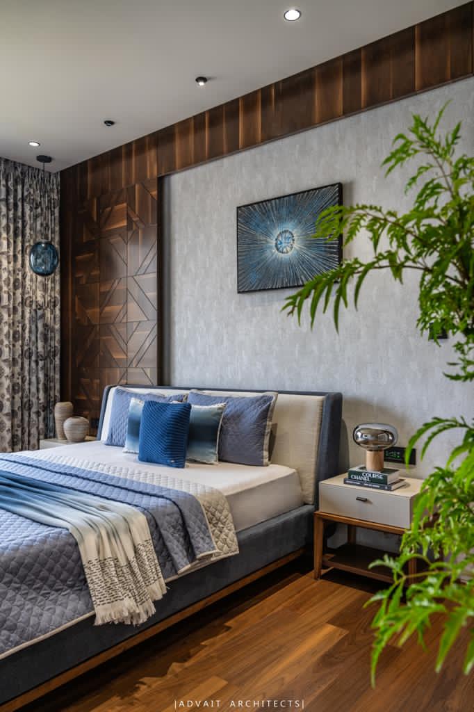 VILLASHBHAI HOME bedside with framed artwork, planting and a timber nightstand